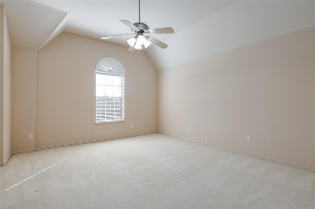 empty room with lofted ceiling, ceiling fan, and light carpet