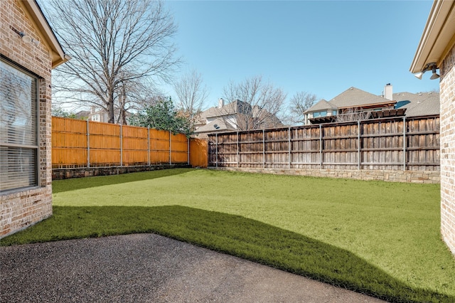 view of yard with a fenced backyard