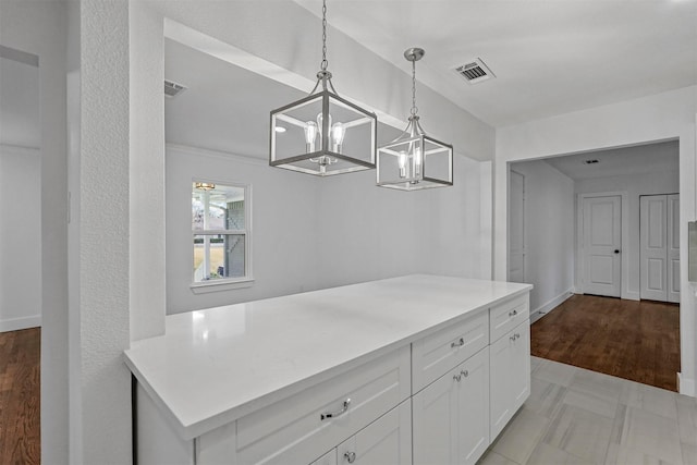 kitchen featuring white cabinetry and pendant lighting