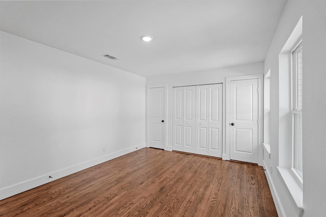 unfurnished bedroom featuring hardwood / wood-style flooring