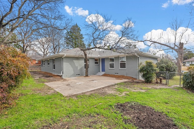 rear view of house with a yard and a patio area