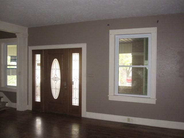 entryway featuring dark hardwood / wood-style floors and a textured ceiling