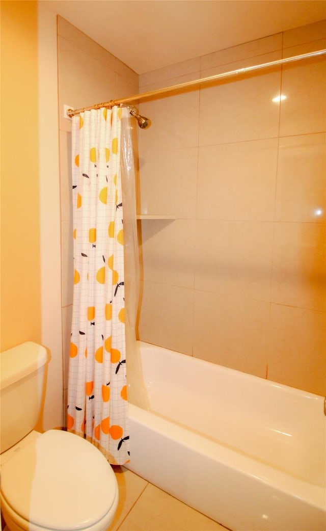 bathroom featuring tile patterned flooring, toilet, and shower / bath combo with shower curtain