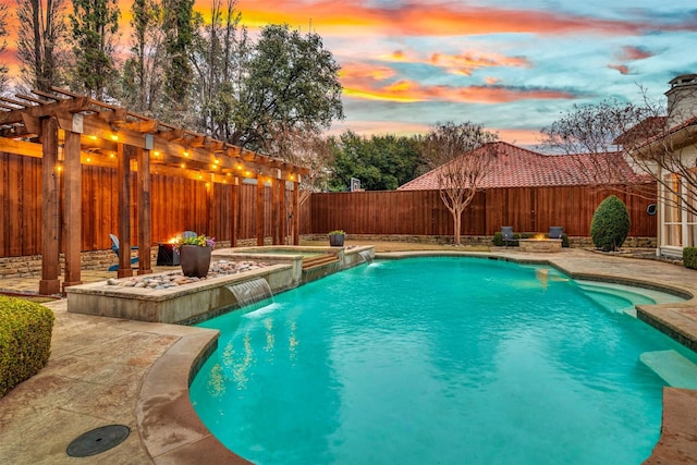 pool at dusk with pool water feature, an in ground hot tub, a pergola, and a patio area