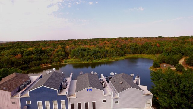 birds eye view of property featuring a water view and a view of trees