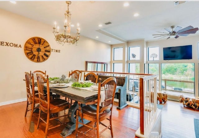 dining space featuring visible vents, baseboards, wood finished floors, recessed lighting, and ceiling fan with notable chandelier