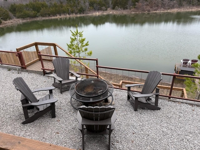 view of patio featuring a water view and a fire pit