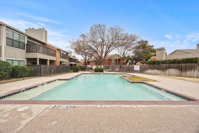 view of swimming pool featuring pool water feature