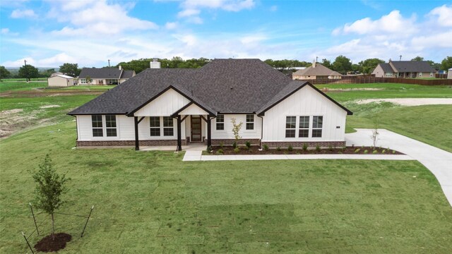 9 Louis Rd, Sherman, TX 75090 - view of front of home with roof with shingles, a front yard, and fence