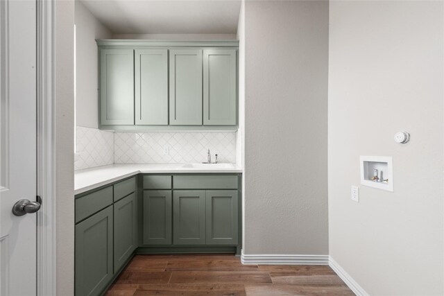 9 Louis Rd, Sherman, TX 75090 - laundry area featuring a sink, cabinet space, baseboards, dark wood-type flooring, and washer hookup
