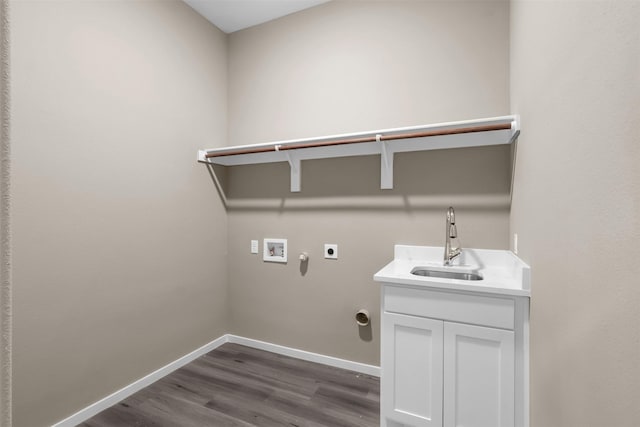 laundry area featuring sink, cabinets, dark hardwood / wood-style flooring, hookup for a washing machine, and electric dryer hookup