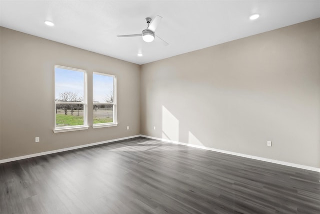 unfurnished room with dark wood-type flooring and ceiling fan