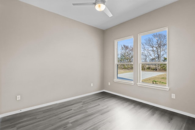 spare room with ceiling fan and dark hardwood / wood-style flooring