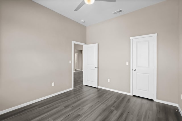 unfurnished bedroom featuring dark wood-type flooring and ceiling fan