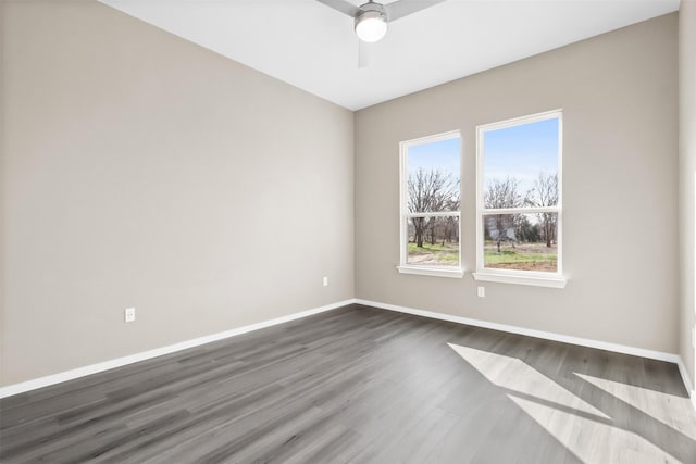 spare room featuring dark wood-type flooring and ceiling fan