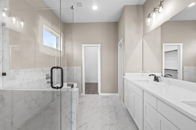 bathroom featuring vanity and an enclosed shower