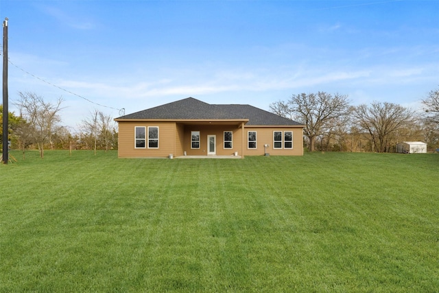 rear view of house with a patio and a yard