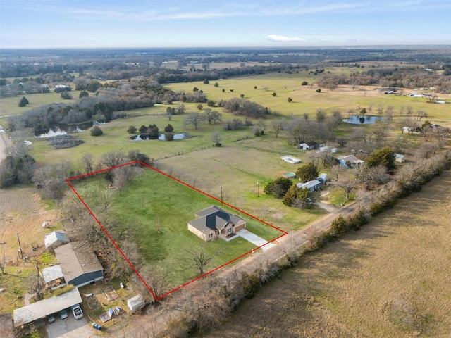 birds eye view of property with a water view and a rural view