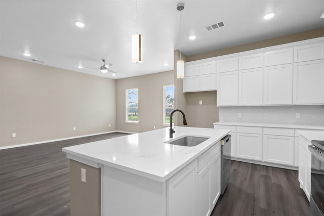 kitchen featuring white cabinetry, an island with sink, sink, hanging light fixtures, and stainless steel appliances