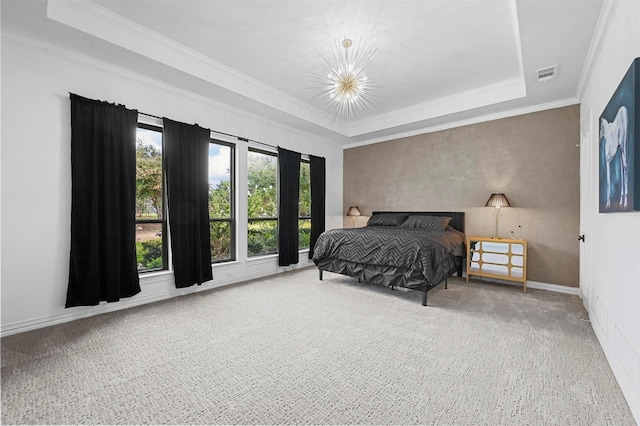 bedroom with ornamental molding and a tray ceiling