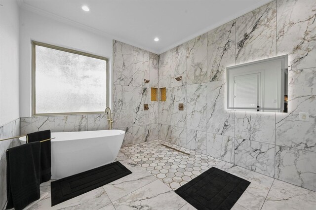 bathroom with crown molding, a bathtub, and tile walls