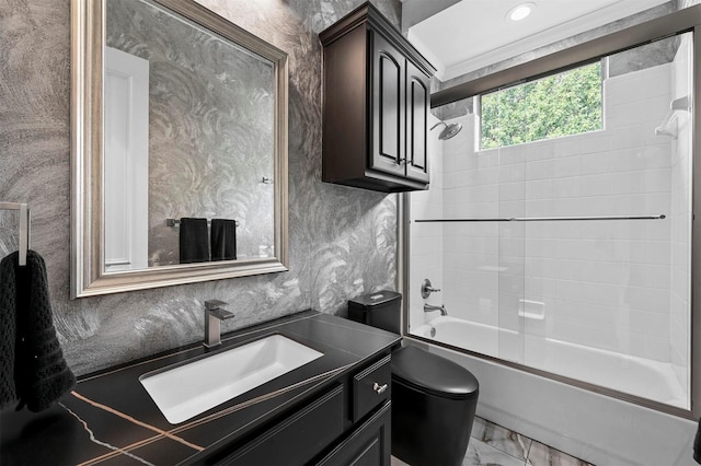 full bathroom featuring vanity, shower / bath combination with glass door, and toilet