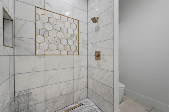 bathroom featuring toilet and tiled shower
