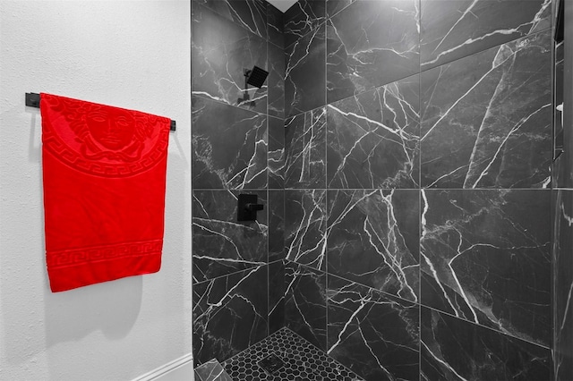 bathroom with tiled shower