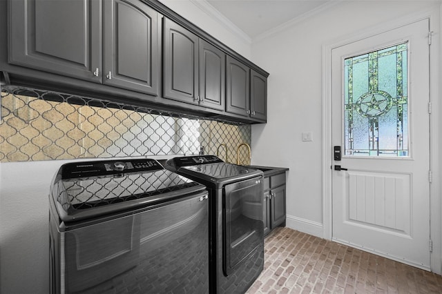 clothes washing area featuring cabinets, ornamental molding, and independent washer and dryer