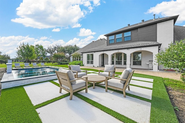 rear view of house featuring an outdoor hangout area and a patio