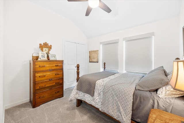 carpeted bedroom featuring lofted ceiling, a closet, and ceiling fan