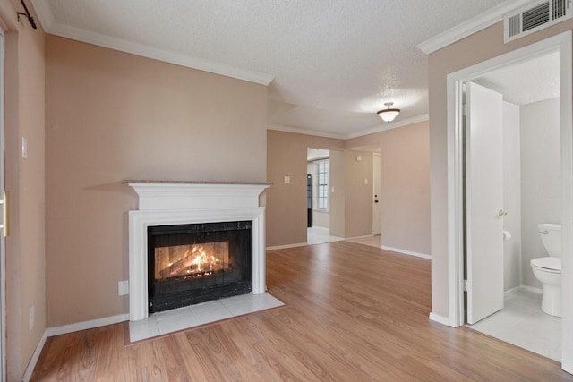 unfurnished living room with crown molding, light hardwood / wood-style flooring, and a textured ceiling