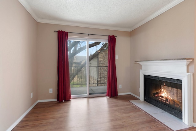 unfurnished living room featuring ornamental molding, light hardwood / wood-style floors, and a textured ceiling