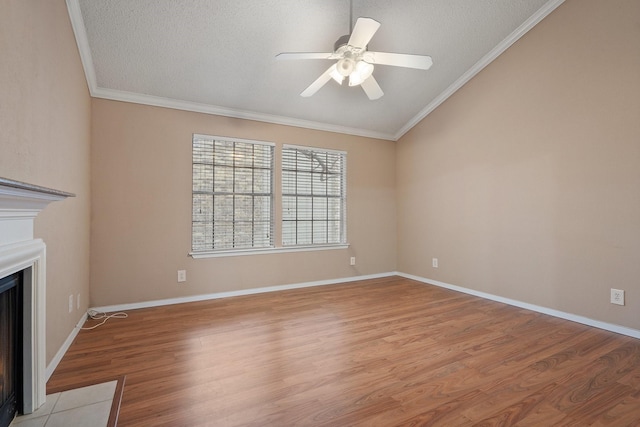 unfurnished living room featuring a textured ceiling, light hardwood / wood-style flooring, ornamental molding, and ceiling fan