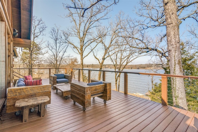 wooden deck featuring an outdoor living space and a water view