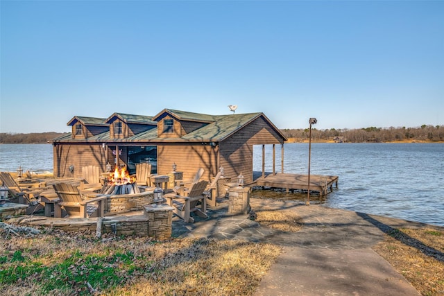 view of dock featuring a water view and a fire pit