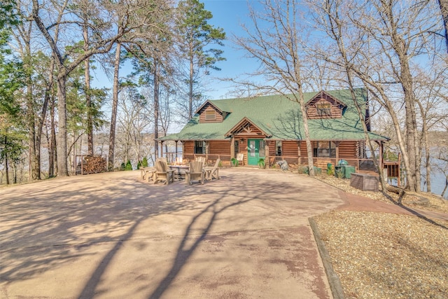 log-style house featuring a patio area