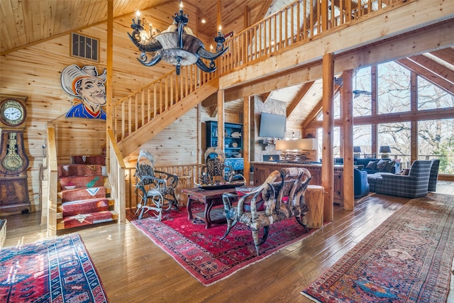 interior space featuring wood ceiling, hardwood / wood-style flooring, high vaulted ceiling, and wood walls