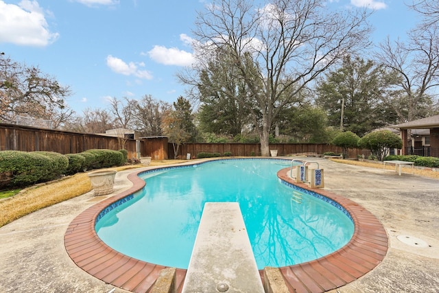 view of pool featuring a patio area and a diving board