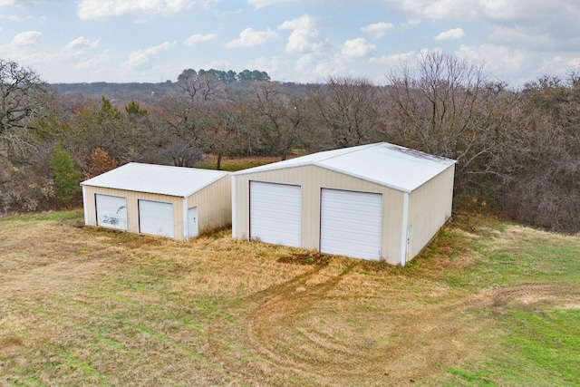 view of outdoor structure with a garage and a yard