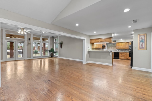 unfurnished living room with light hardwood / wood-style floors, french doors, and ceiling fan