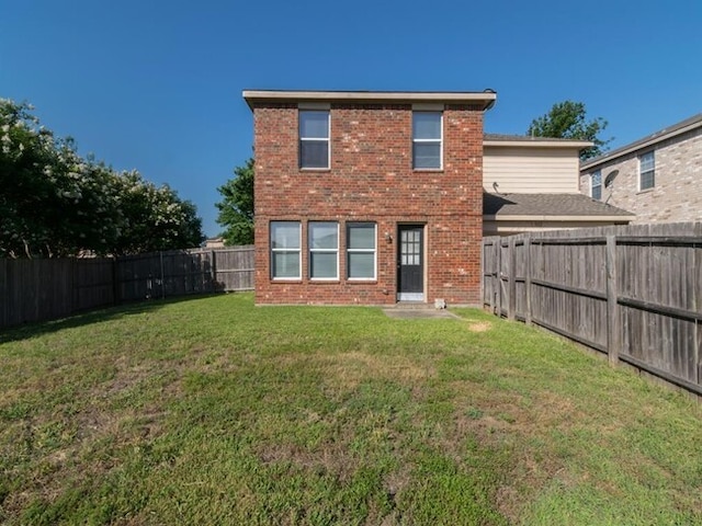 rear view of property with a lawn