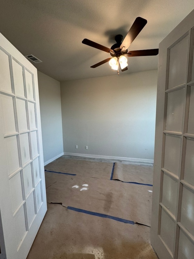 spare room with a chandelier, a healthy amount of sunlight, visible vents, and baseboards