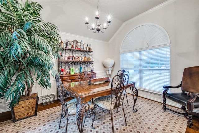 dining area featuring ornamental molding, vaulted ceiling, a notable chandelier, and light hardwood / wood-style flooring