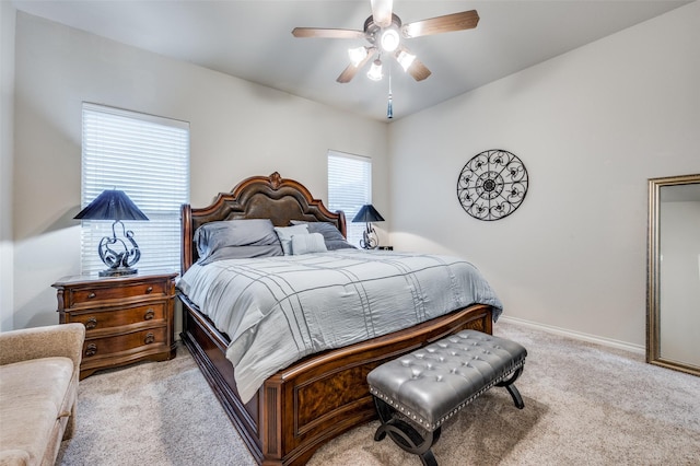 bedroom with ceiling fan and light carpet