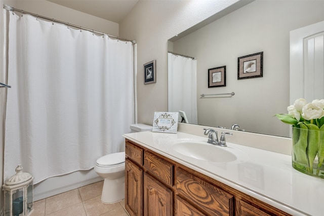 full bathroom featuring shower / bath combo with shower curtain, tile patterned floors, toilet, and vanity