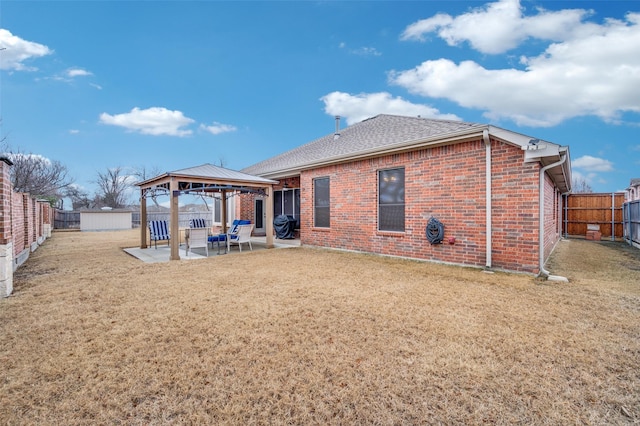 back of property featuring a gazebo, a patio, and a lawn