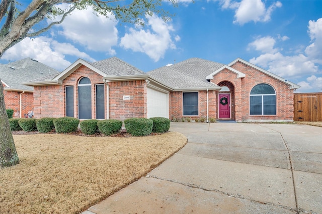ranch-style home with a garage and a front yard