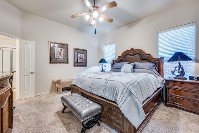 bedroom with ceiling fan and light carpet
