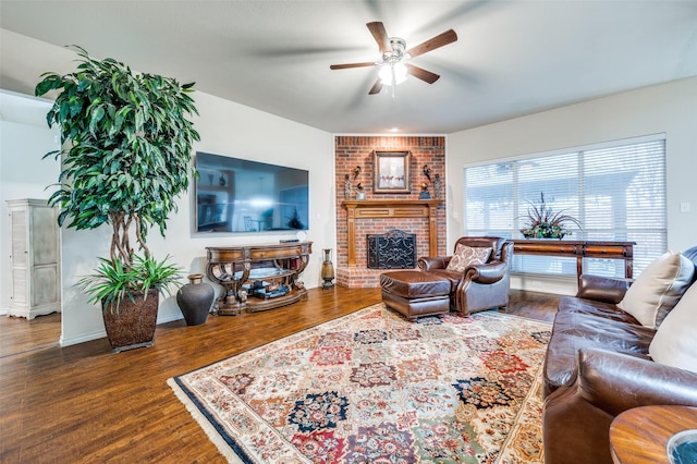 living room featuring a fireplace, dark wood-type flooring, and ceiling fan